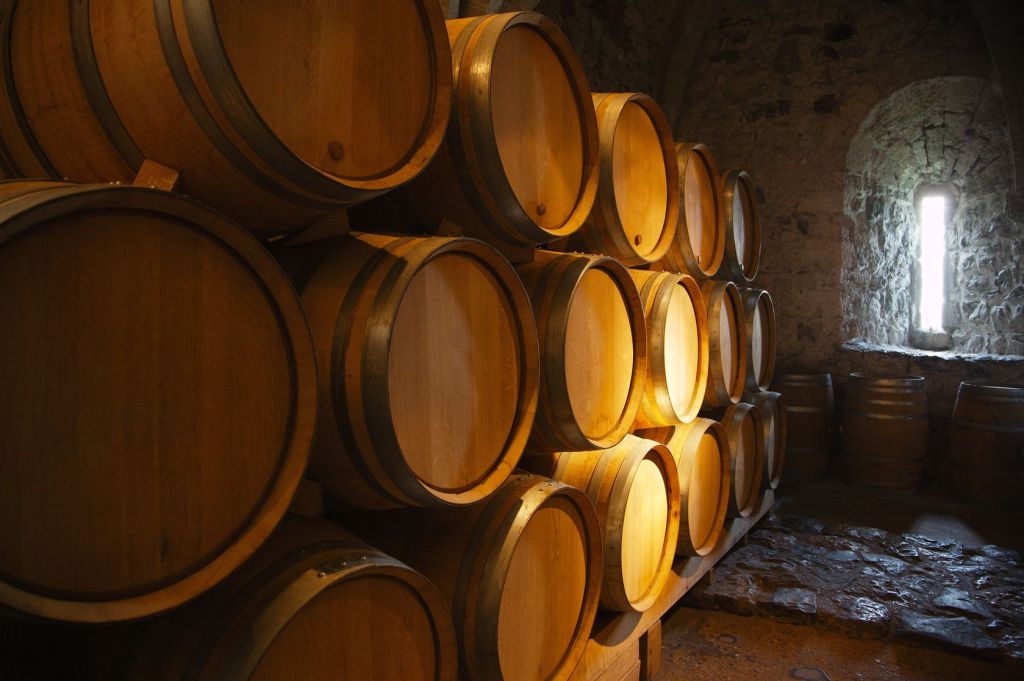 Wine barrels aging in a dark cellar.