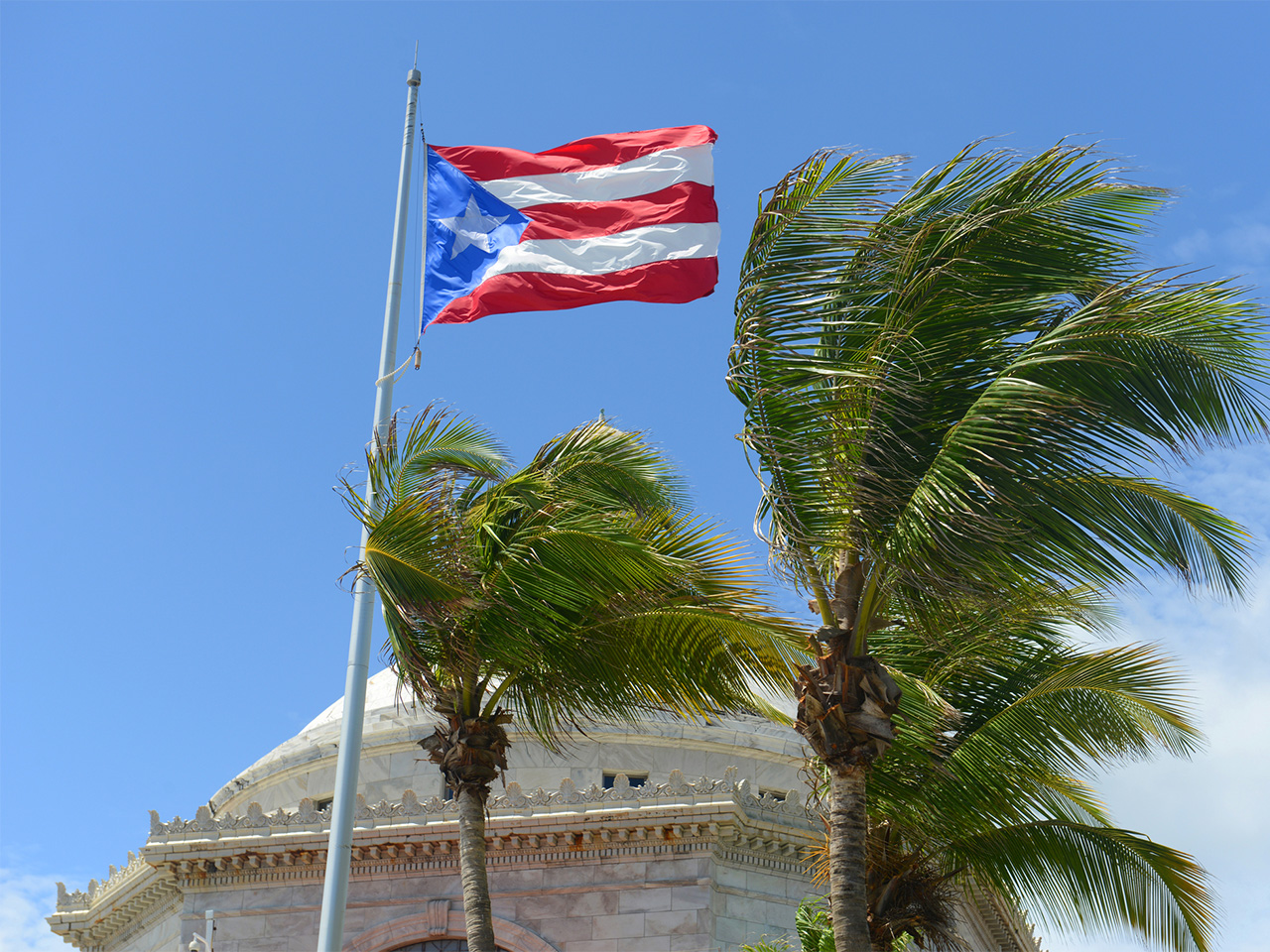 The Puerto Rico flag flies over the capitol in San Juan.