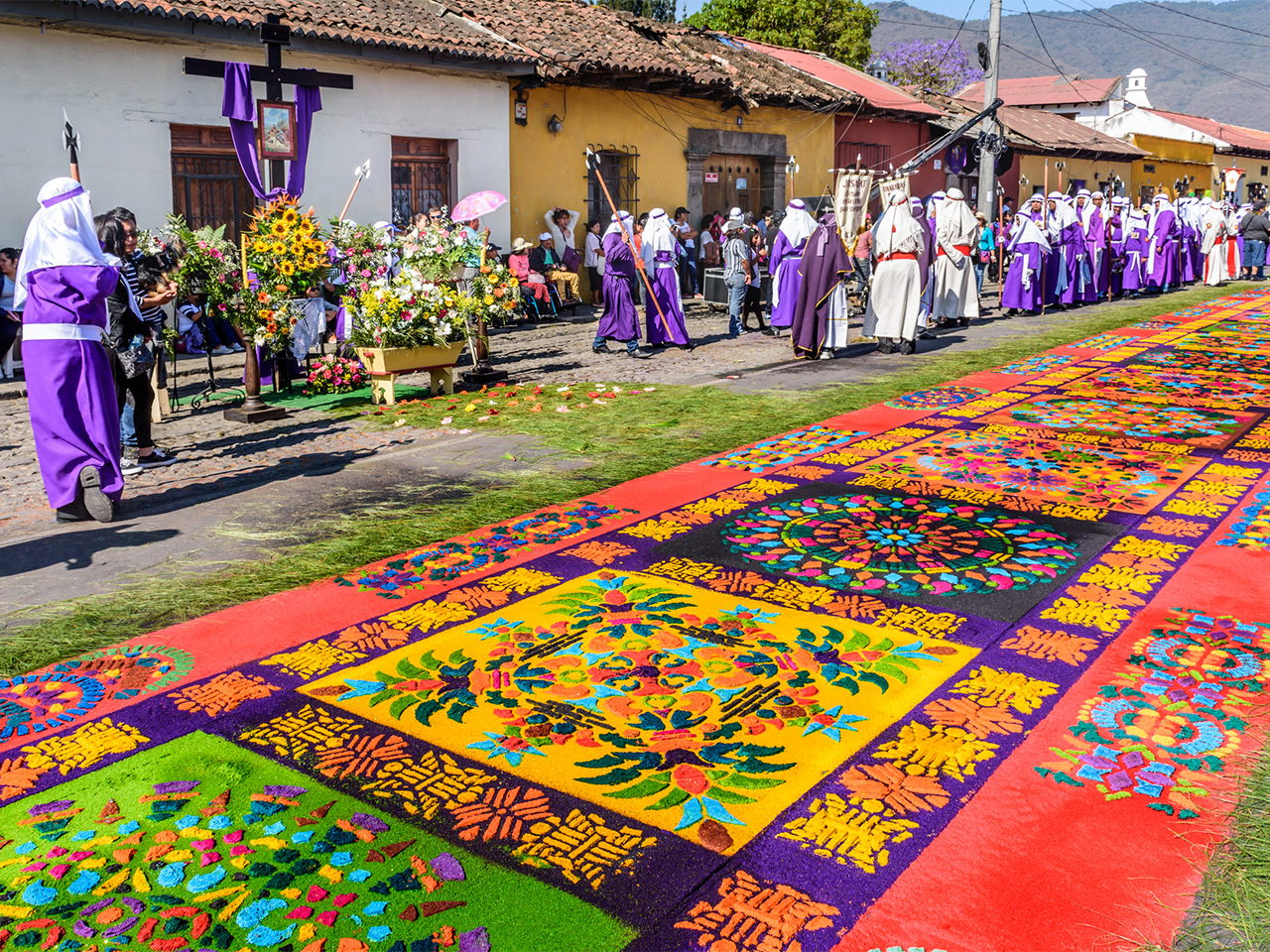 Locals reenact biblical scenes with processions walking over handmade dyed sawdust carpets on Good Friday in colonial town with most famous Holy Week celebrations in Latin America.