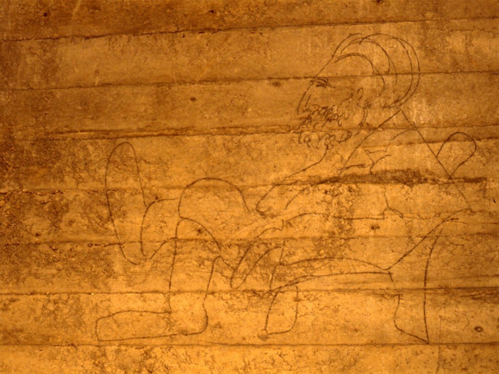 Cartoon line graffiti of a man sitting drawn on the wall of the Lincoln Memorial Undercroft.