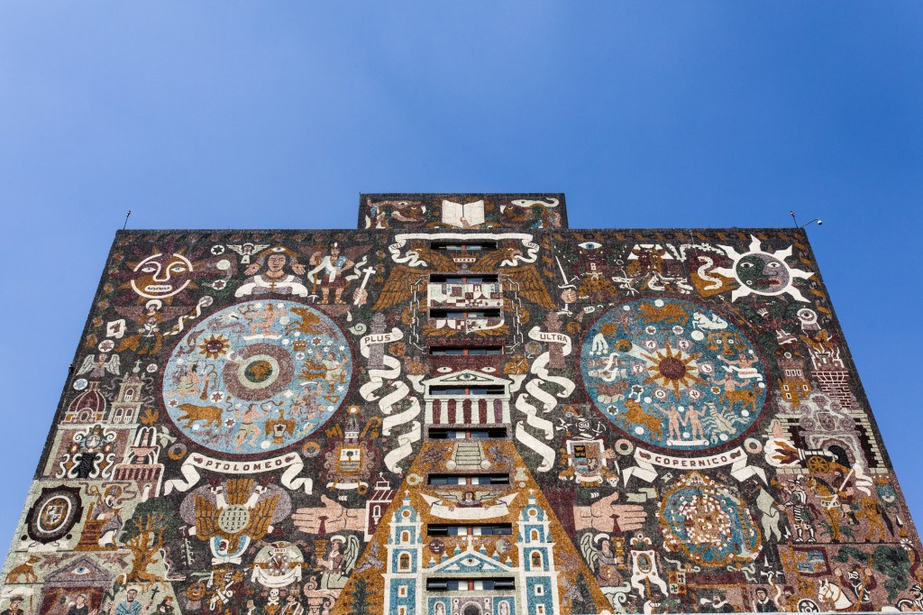Image of brick building covered in intricate mural.