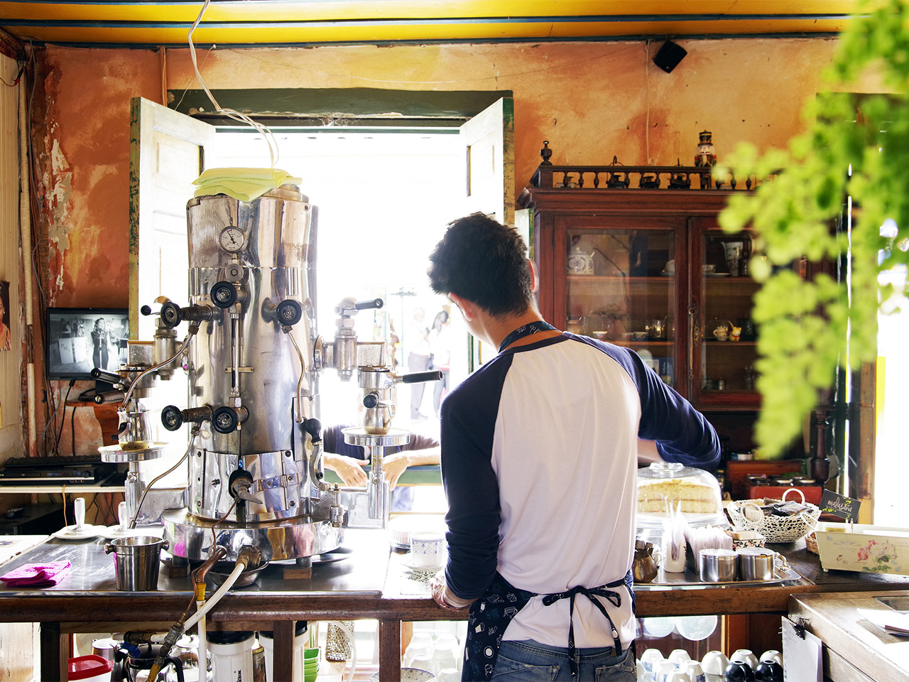A barista pours coffee in an airy coffeehouse in Salento, Colombia.