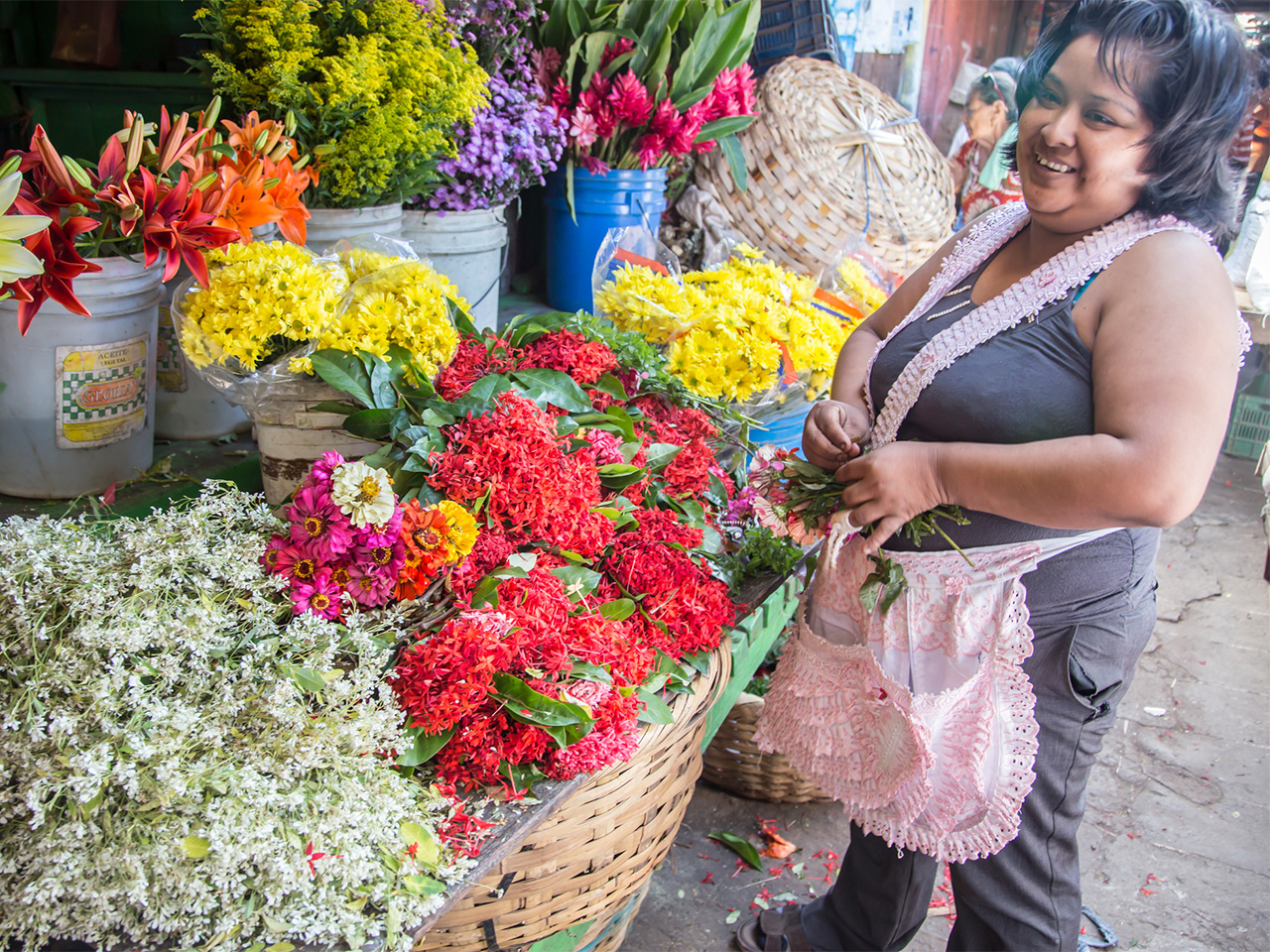 A woman shops for flowers at an open-air market stall in Granada, Nicaragua.