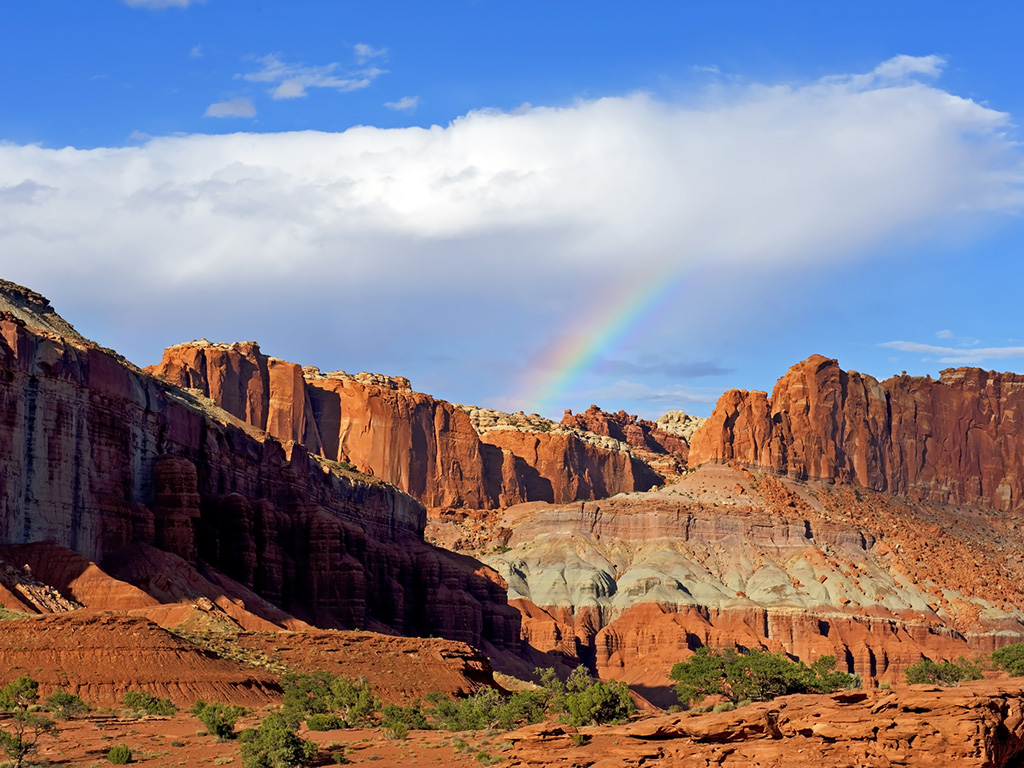 rainbow over rocky scenery at panorama point in capitol reef