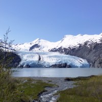 icy glaciers with mountains and a body of water
