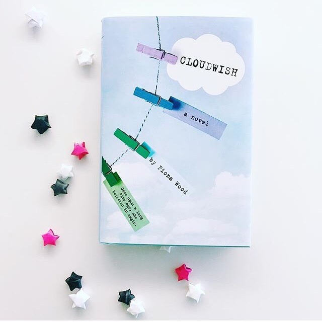 NOVL - Instagram image of book cover for 'Cloudwish' by Fiona Wood with tiny, origami paper stars surrounding the cover
