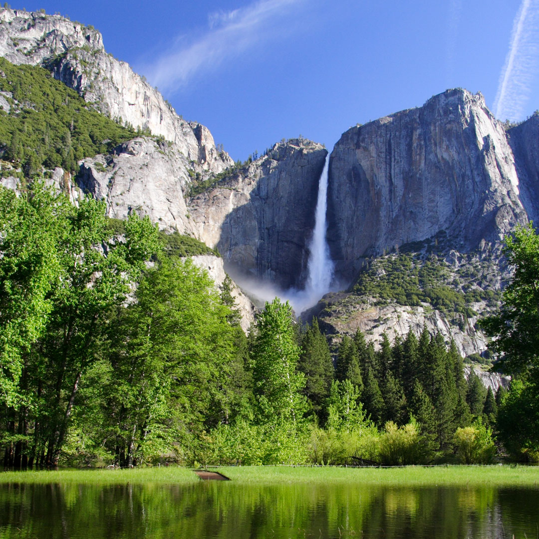 waterfall in Yosemite with lush green landscape