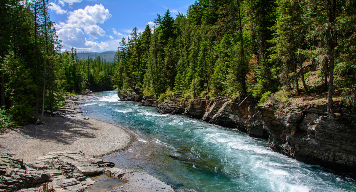 lake with rapids winding through forested riverbanks