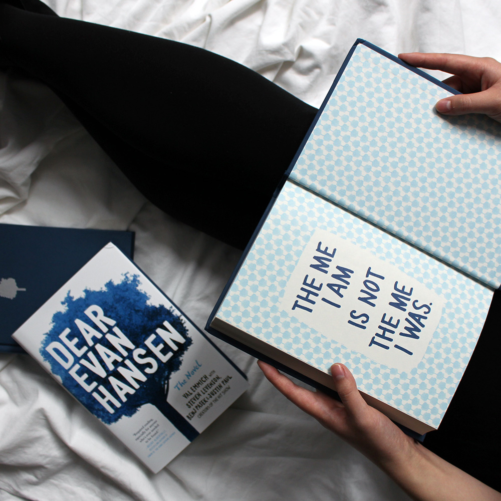 NOVL - Instagram image of book cover and inside back cover for 'Dear Evan Hansen' by Val Emmich reading 'The me I am is not the me I was.'