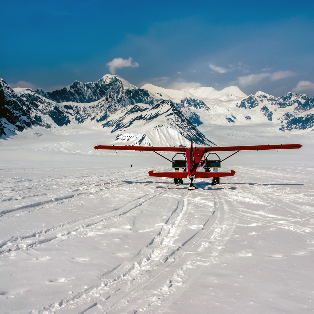 red airplane on Ruth Glacier