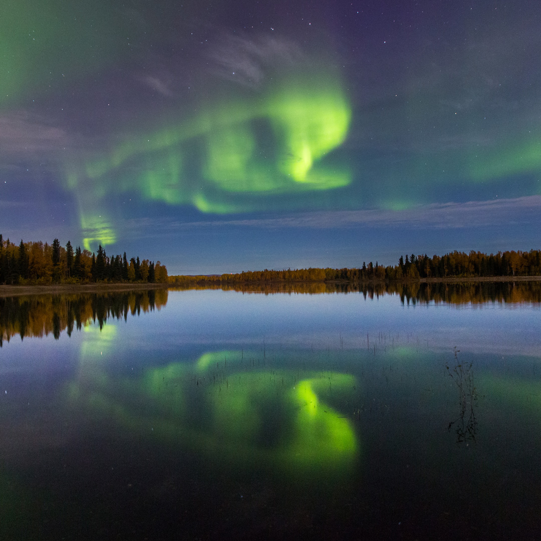 bright green aurora over a lake in Alaska