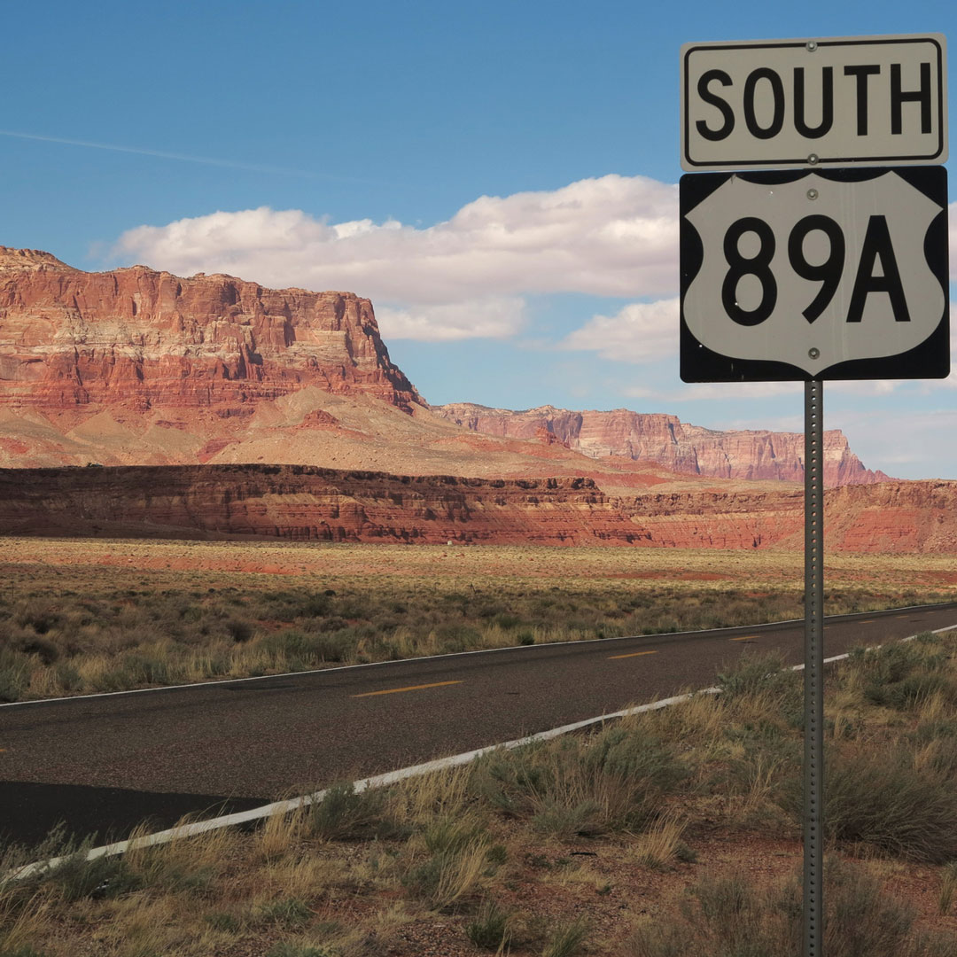 Highway 89a South sign with a view of the Vermilion Cliffs in Arizona