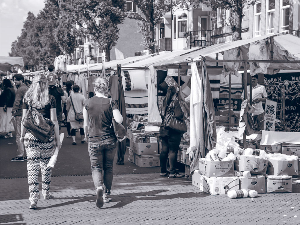 women walking through market stalls in Amsterdam