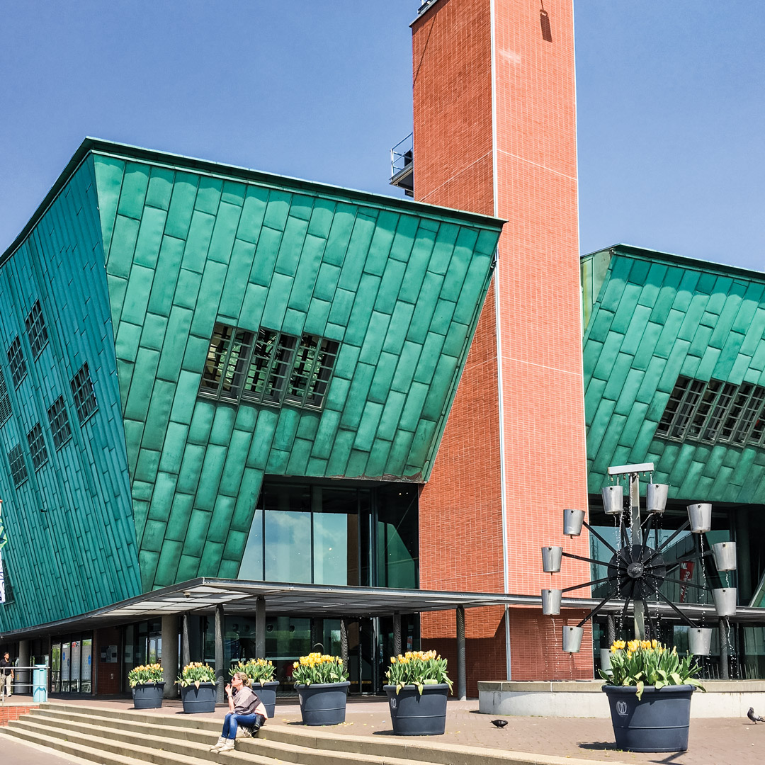angular green and salmon colored museum building in Amsterdam