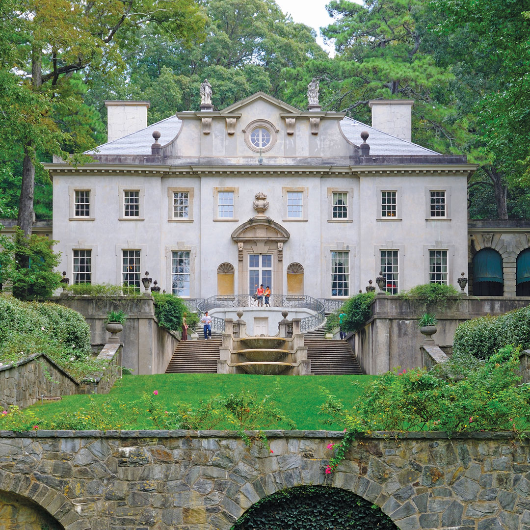 historic swan house mansion surrounded by trees