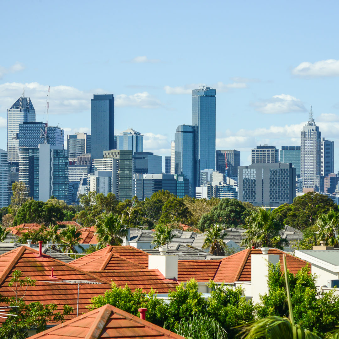 view of the Melbourne skyline over suburban houses