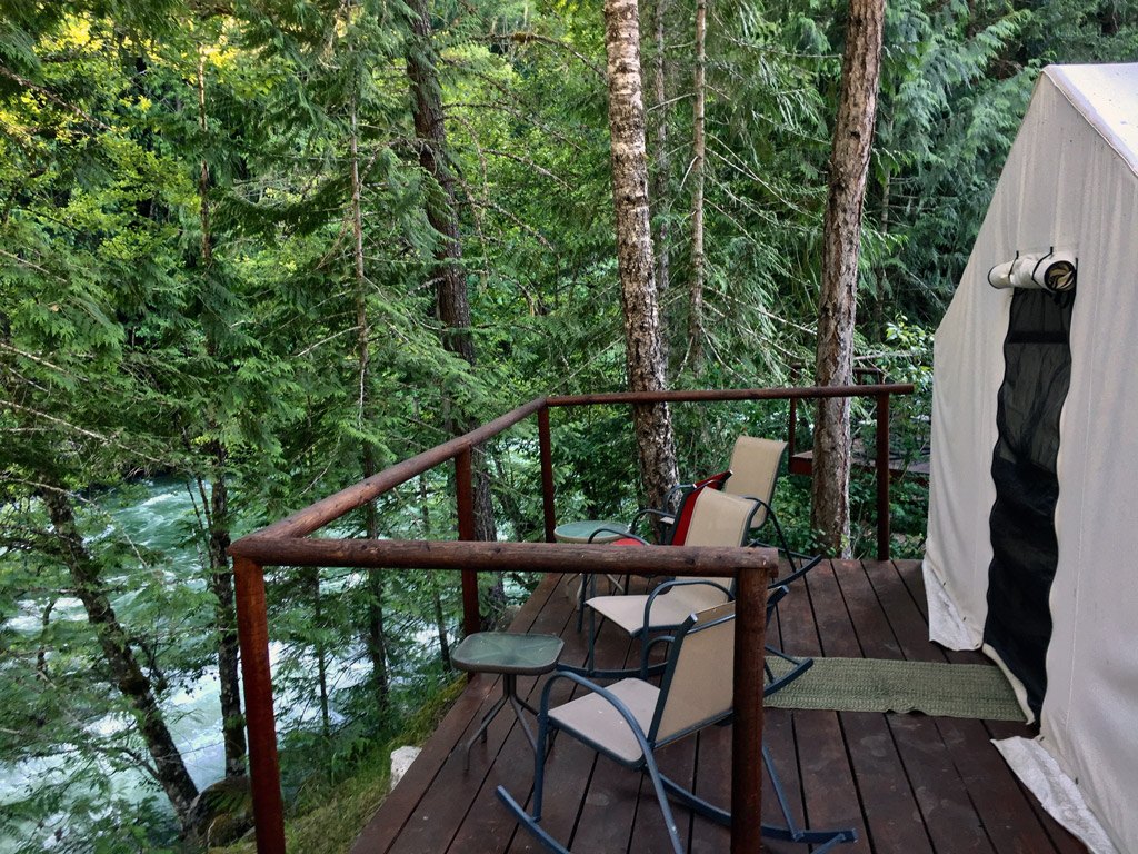 tent on a deck overlooking a river