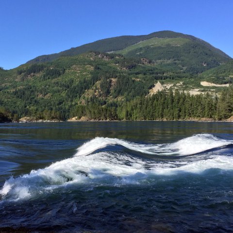 rolling waves with a backdrop of green hills