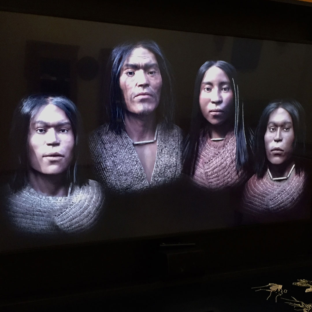 depiction of four indigenous people on a screen