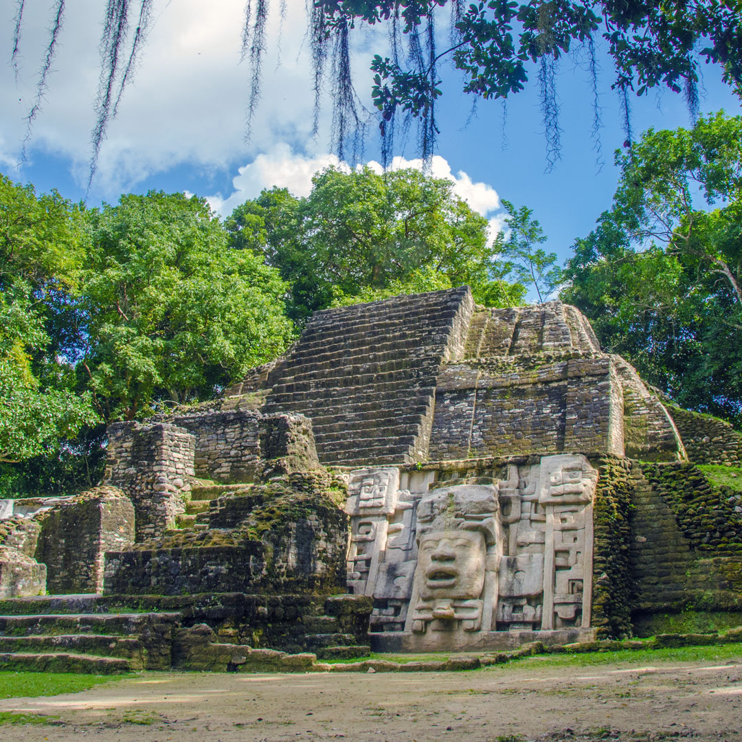 temple of Lamanai Ruins in Belize surrounded by trees