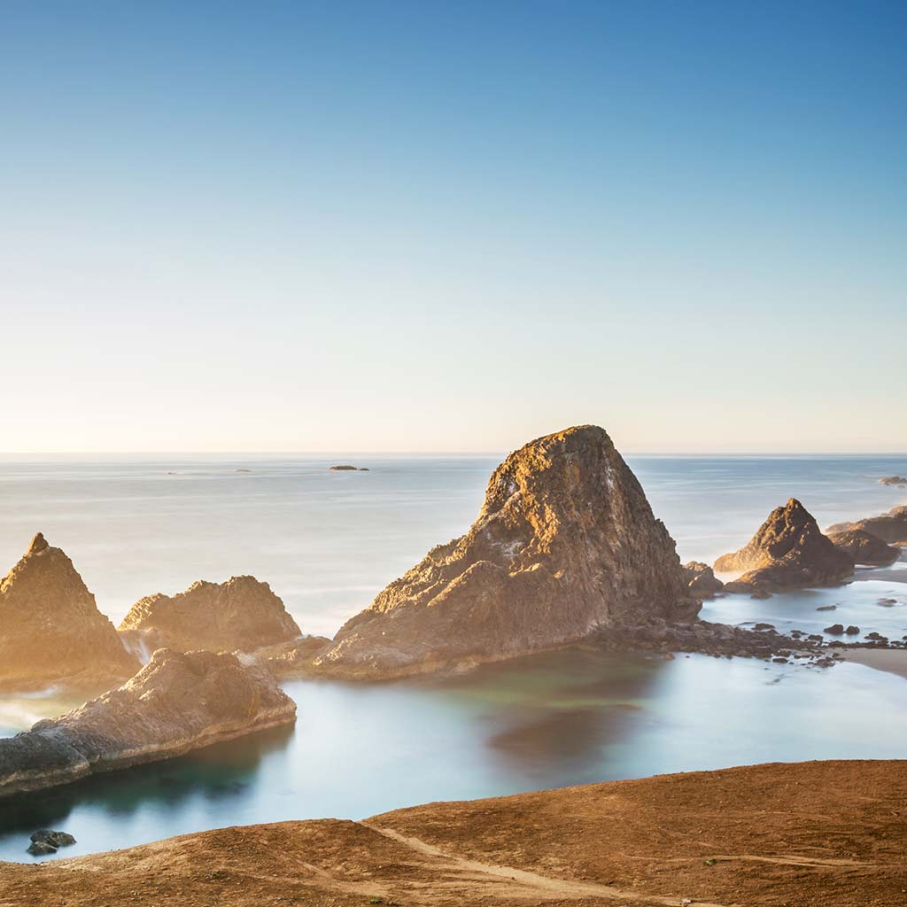 large rocks jutting out of the ocean on the Oregon coast