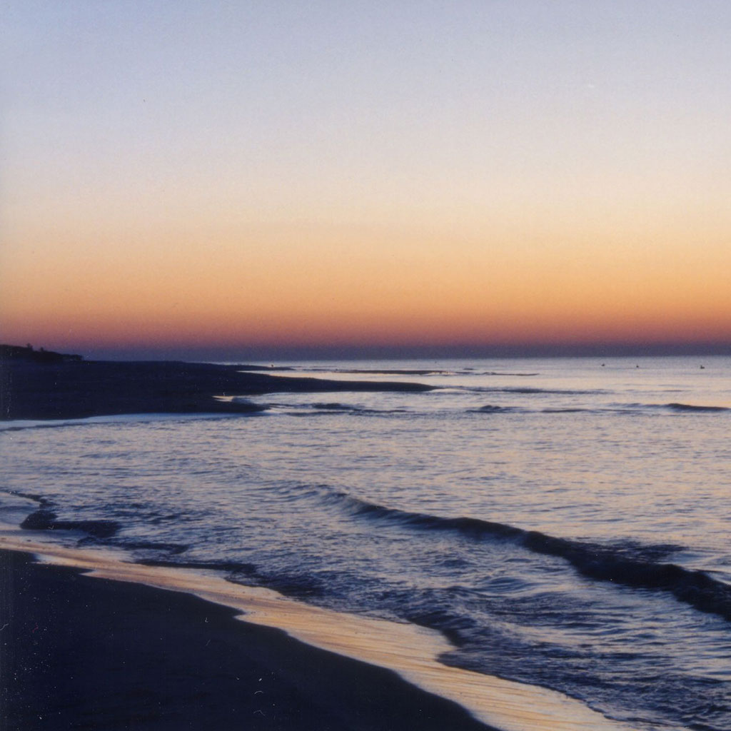 Sunset on Santa Rosa Island featuring gentle waves and a glowing orange sky