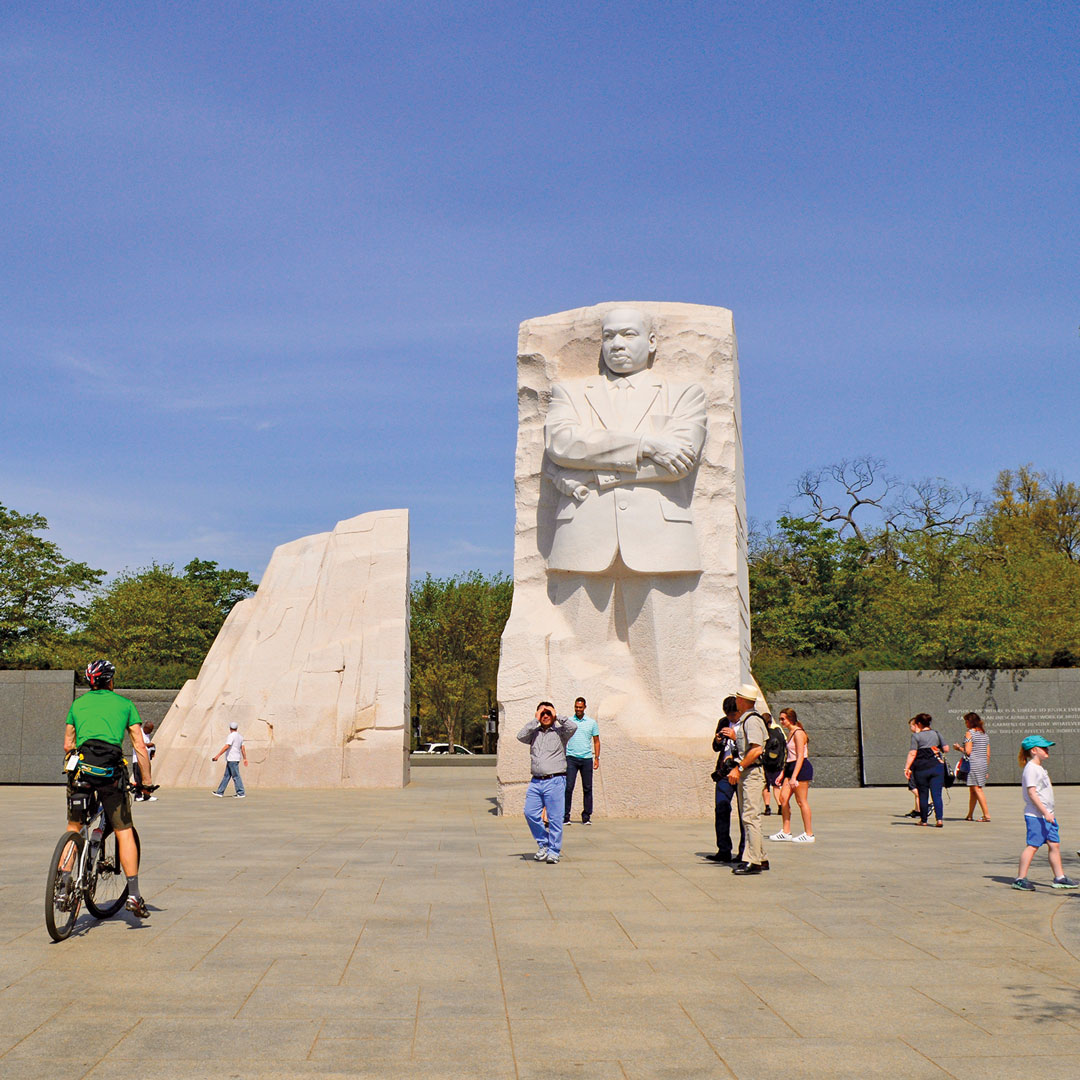 DC visitors milling around a statue of Martin Luther King