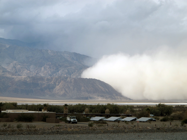 A dust storm travels towards Furnace Creek in Death Valley, California.