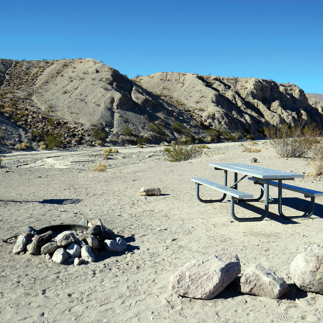 picnic table and campfire in a Mesquite Spring campground in Death Valley