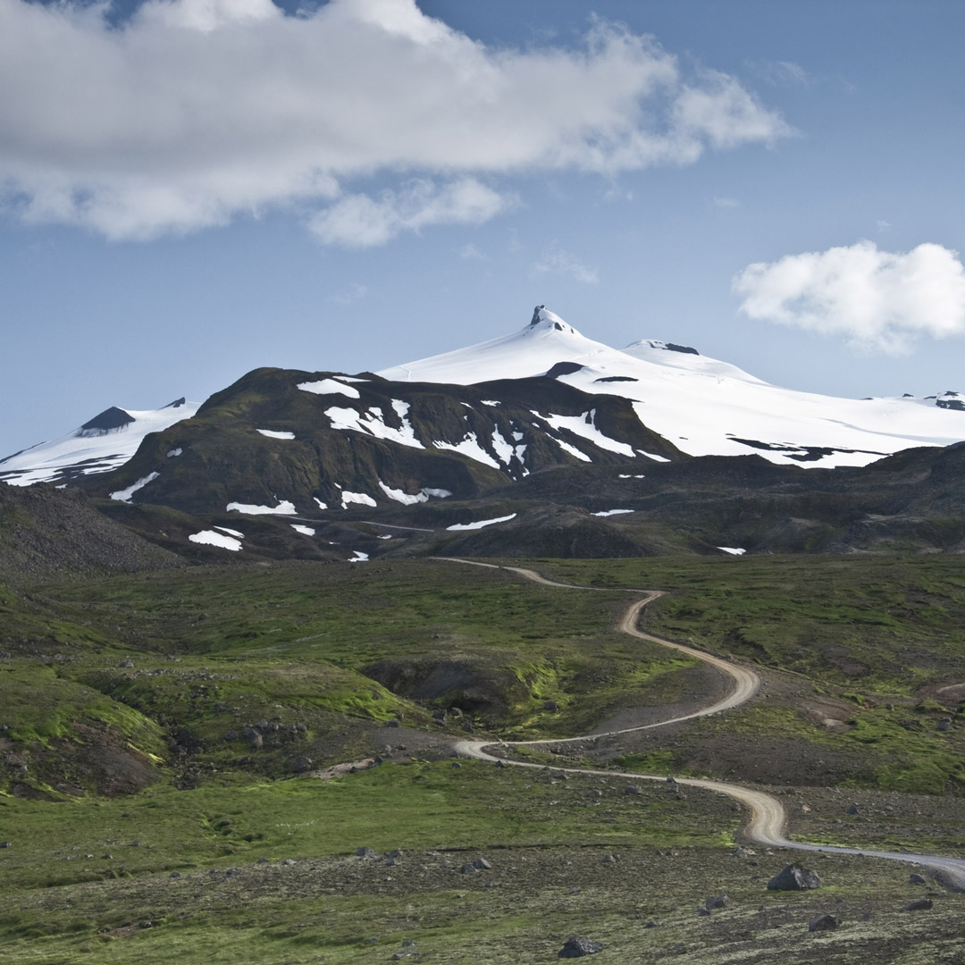 a path winds toward snaefellsjokul glacier in Iceland