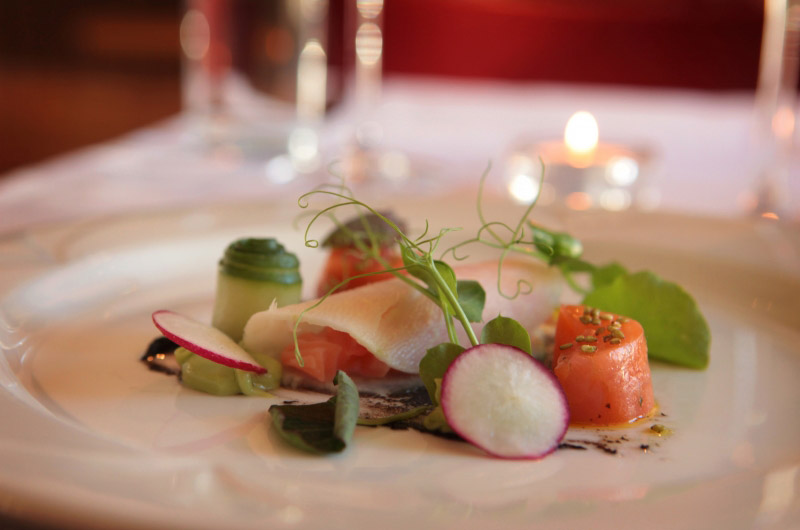 a plate with fish and fresh vegetables