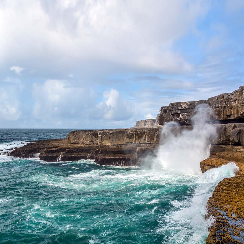 Waves crash along the cliffs of Inis Mór in Northwest Ireland