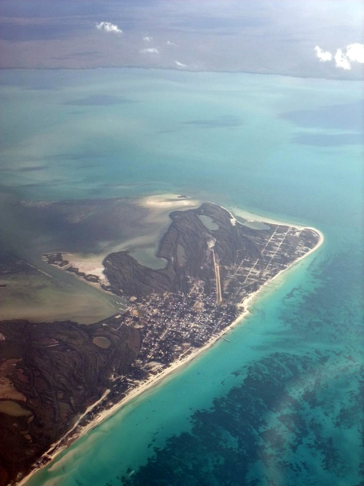 Aerial view of Isla Holbox's miles of beach, with the mainland of the Yucatán Peninsula in the distance.