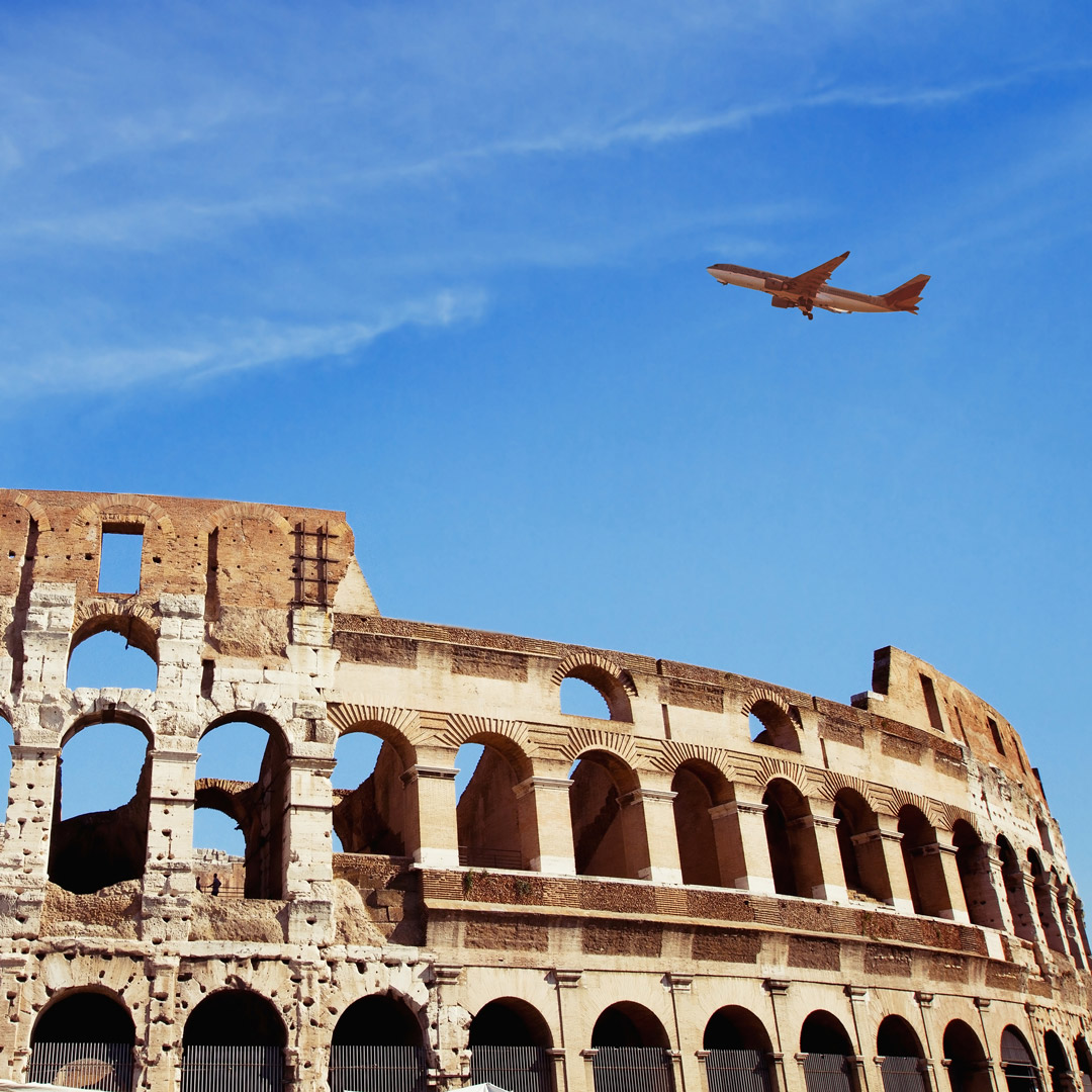 plane flying over the Coliseum in Rome, Italy