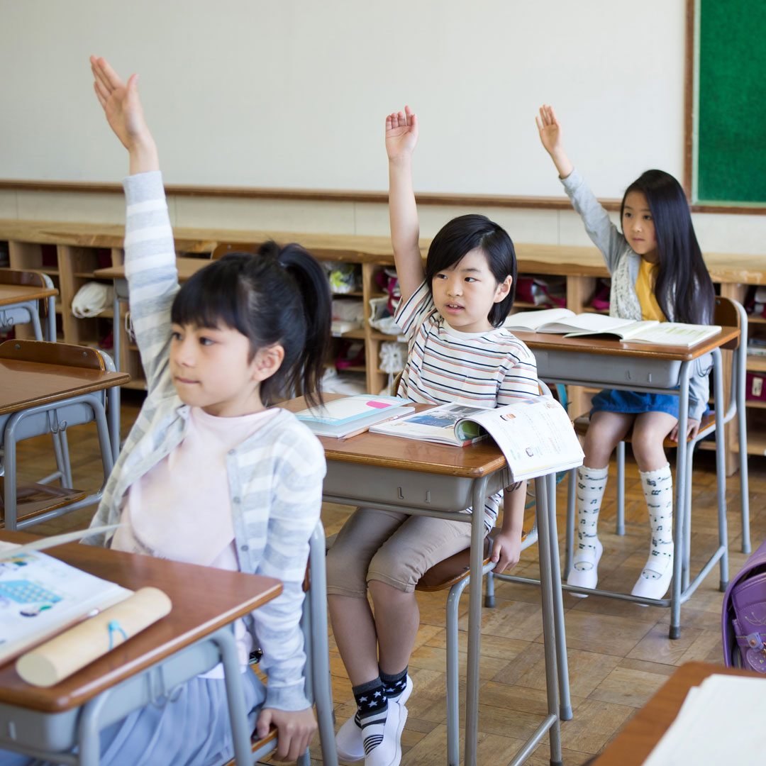 Japanese students raising their hands