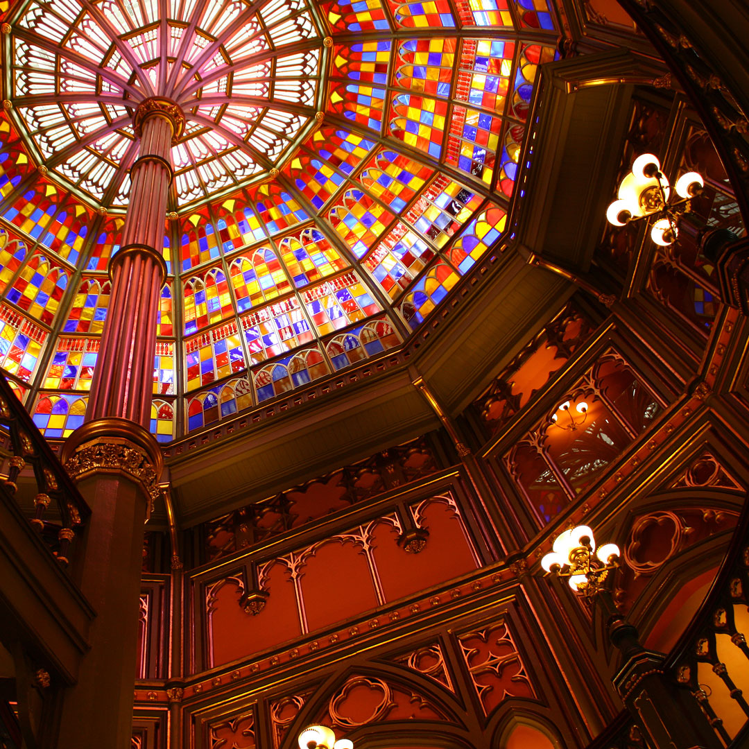 light shines through a stained glass ceiling inside the old state capitol building in Baton Rouge