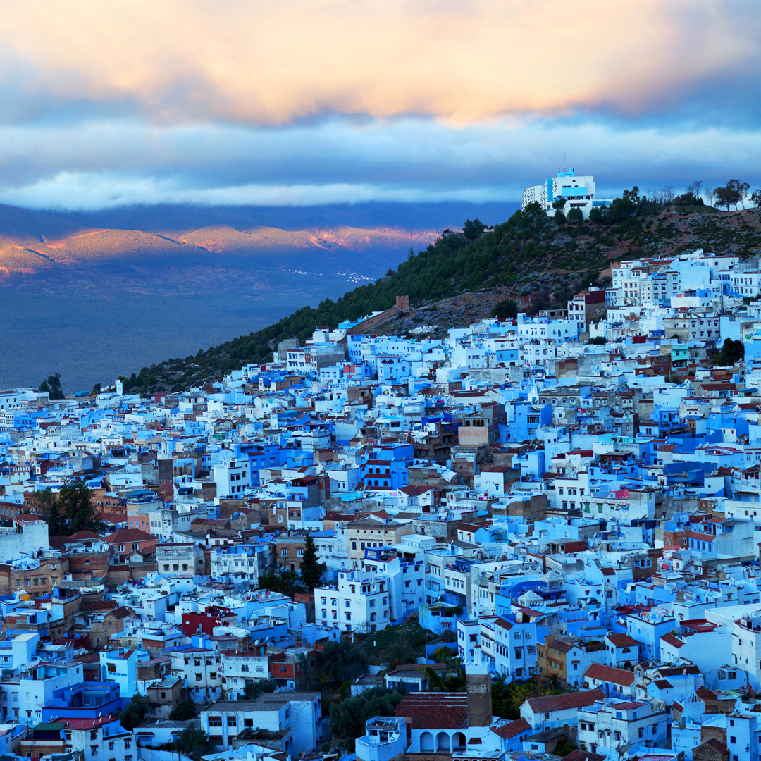 aerial view of Morocco's blue city of Chefchaouen with clouds overhead