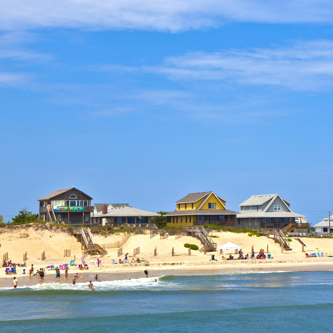 people playing on the beach in front of cottages at Nags Head in North Carolina