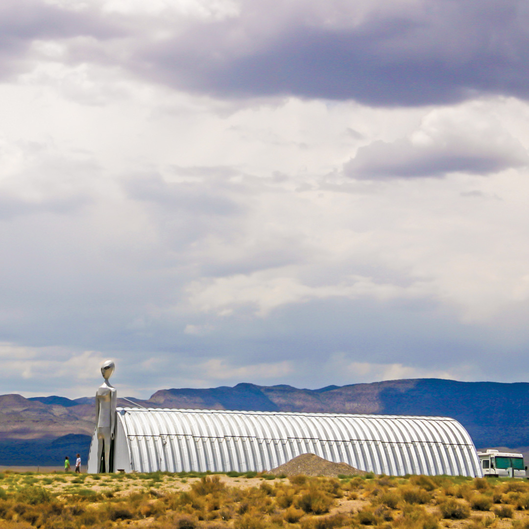 quanset hut next to a large alien figure in Nevada