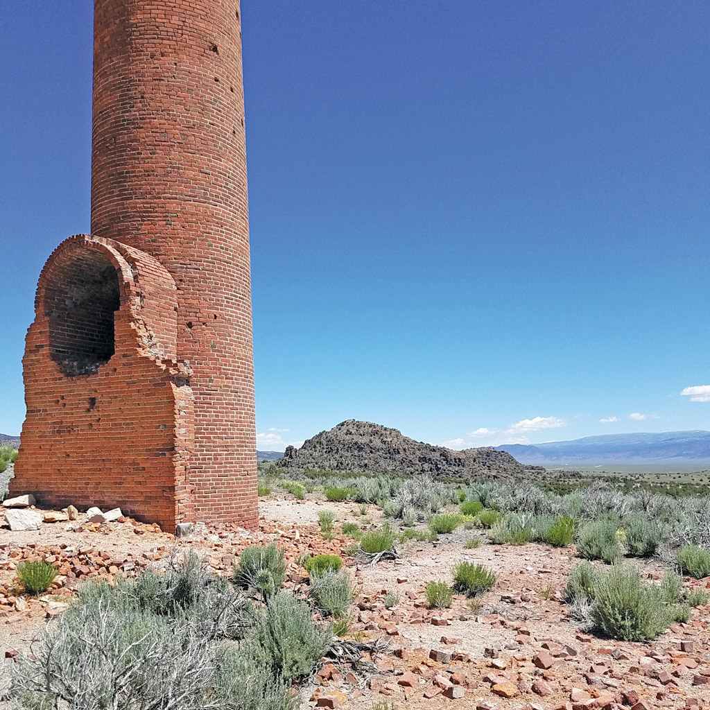 desert landscape with a lone smokestack ruin in Nevada