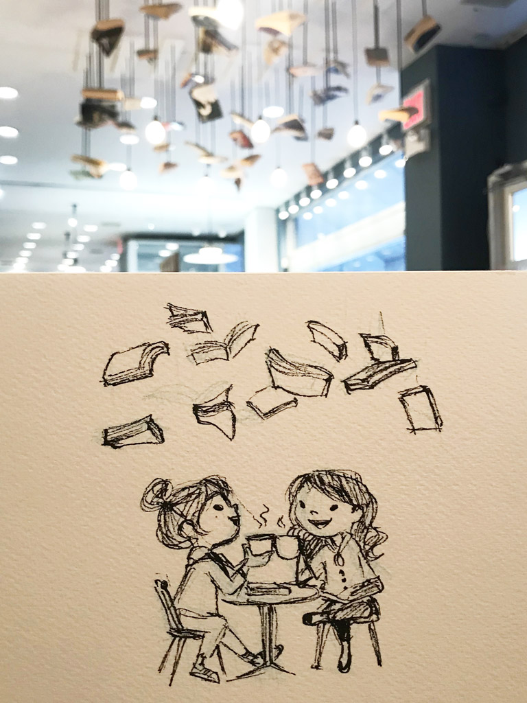 books hanging from the ceiling at mcnally jackson books with a sketch of the scene