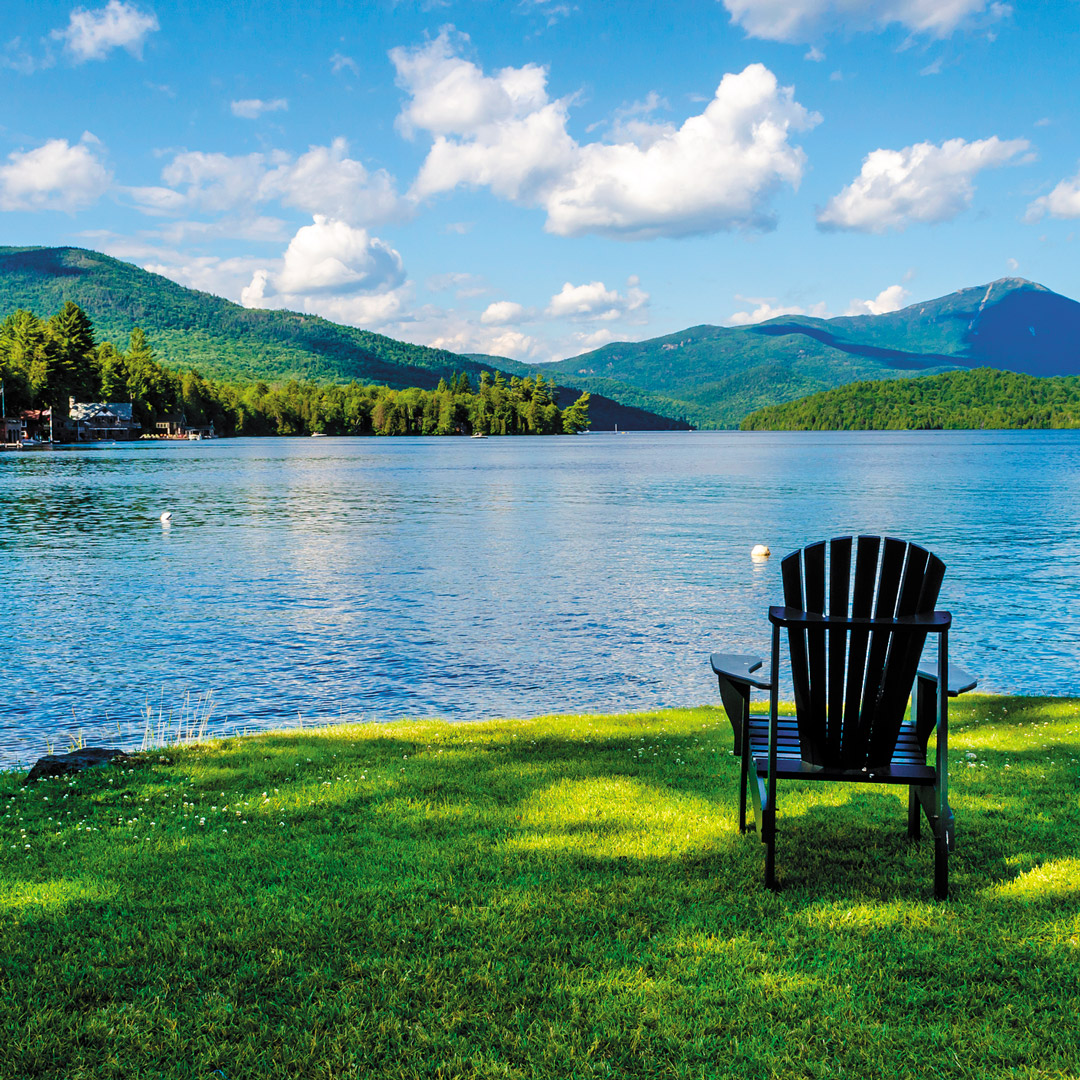 adirondack chair sitting on the shores of Lake Placid