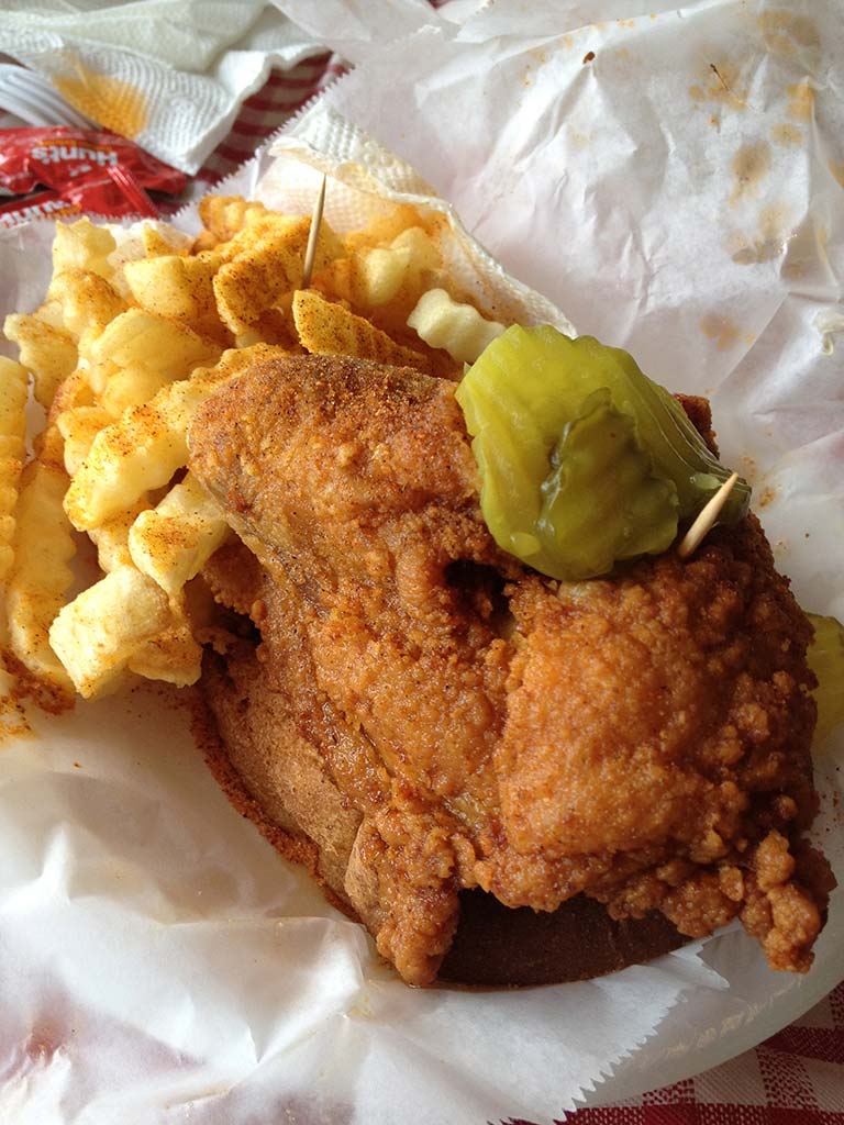 Hot chicken, served on Wonder bread with a pickle, is a signature Nashville dish. Photo © Margaret Littman.