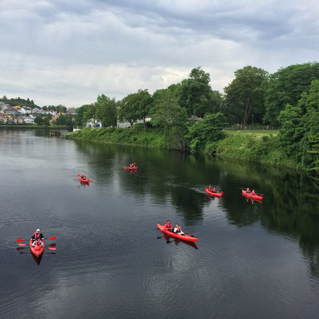 bright red kayaks on a river in Trondheim, Norway