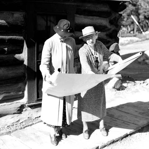 Black and white photo of Mary Colter showing a blueprint to Mrs. Ickes
