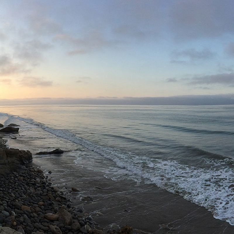 Shoreline with gentle waves at sunset