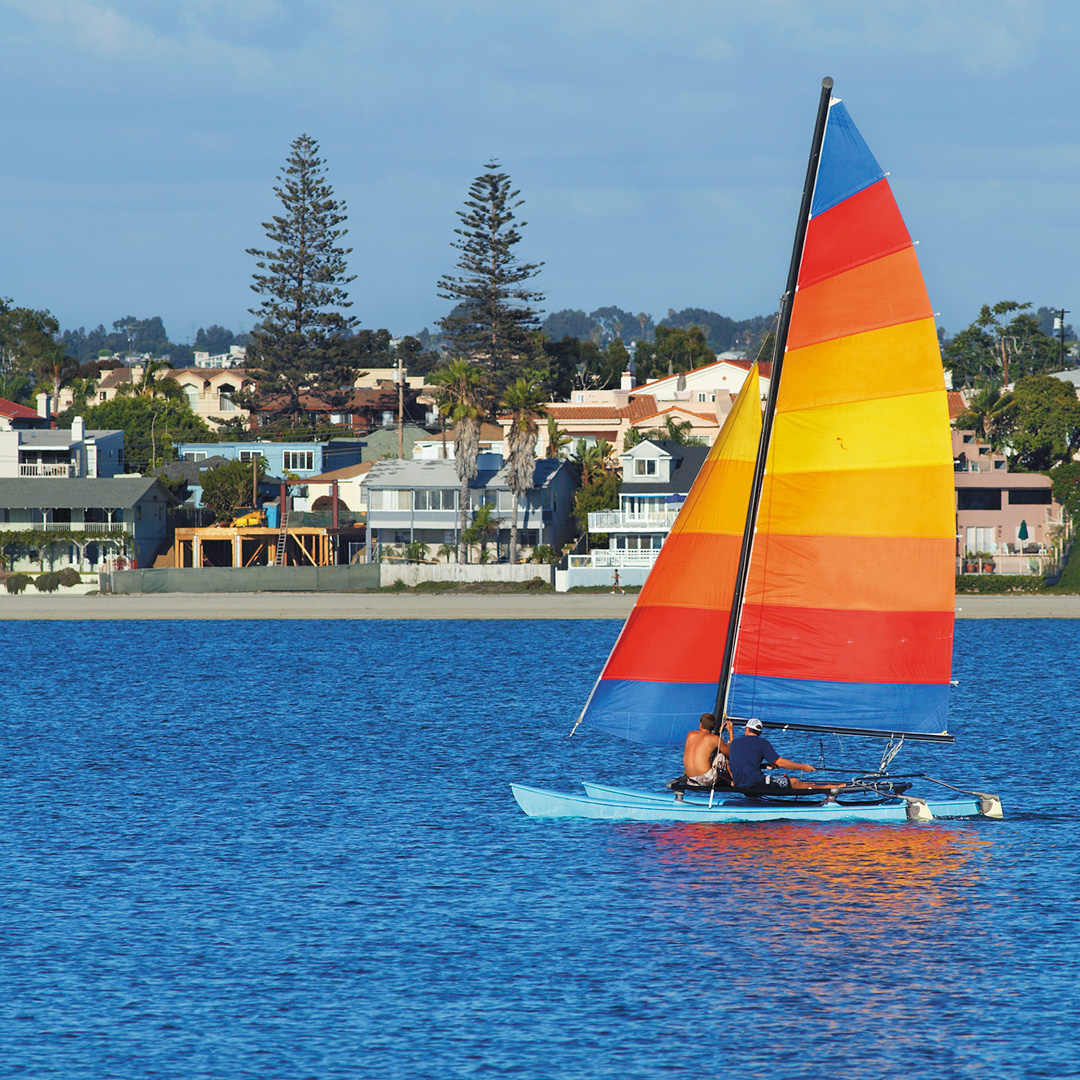 rainbow colored sailboat in Mission Bay San Diego