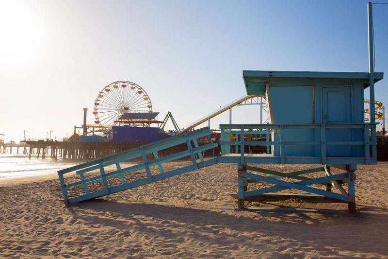 A lifeguard station on the beach next to the Santa Monica Pier.