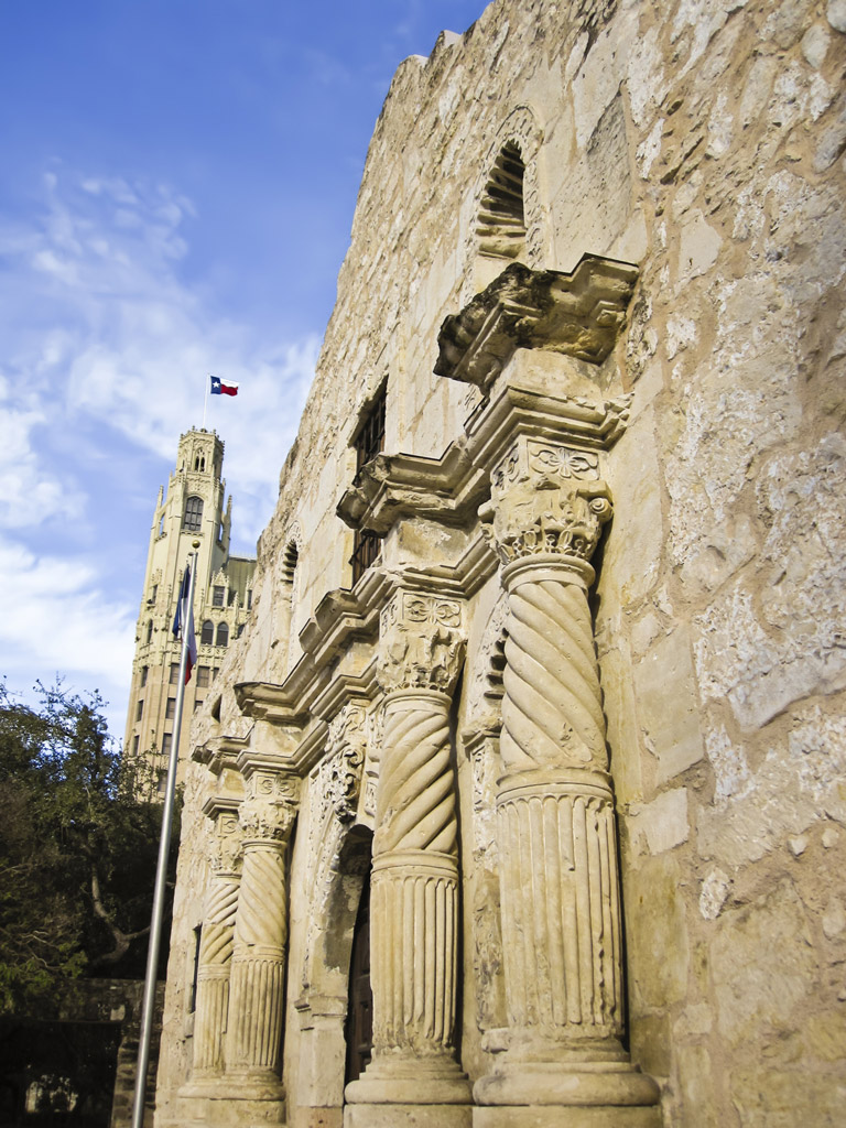 view of the front facade of the Alamo with blue sky above it