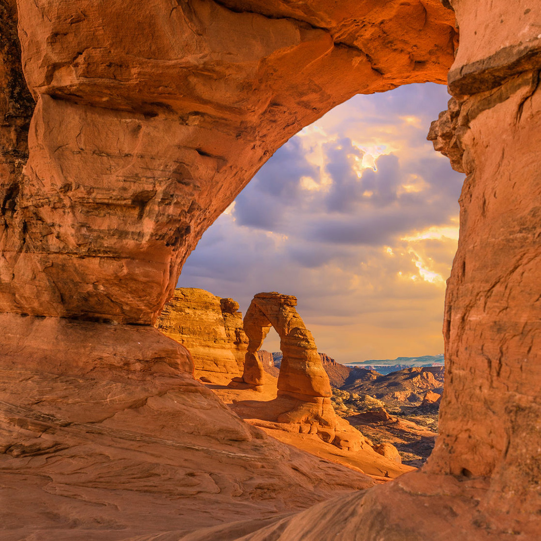 view through sandstone arches at sunset